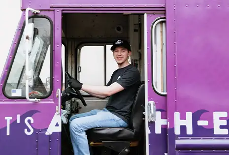 Buoy Bowls employee driving the purple truck