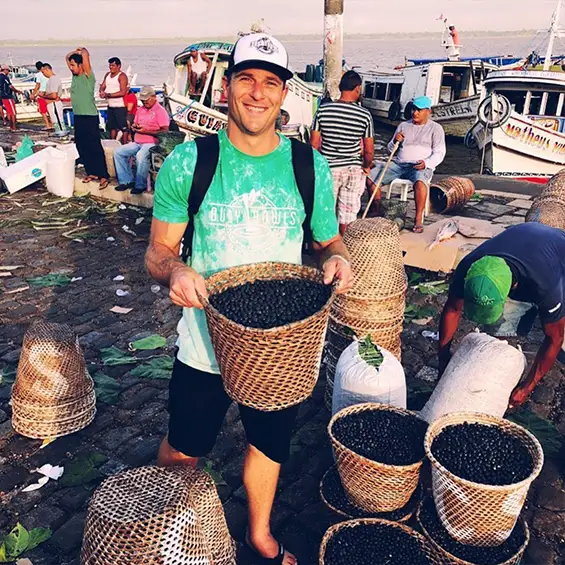 Founder Derek Sharpe harvesting açaí berries in Brazil.
